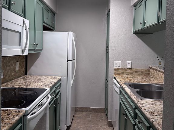 Kitchen with microwave, stove/oven, refrigerator, dishwasher and garbage disposal.