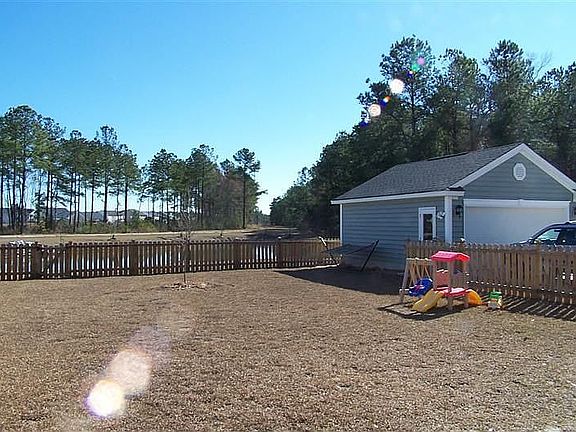 fenced backyard overlooks pond