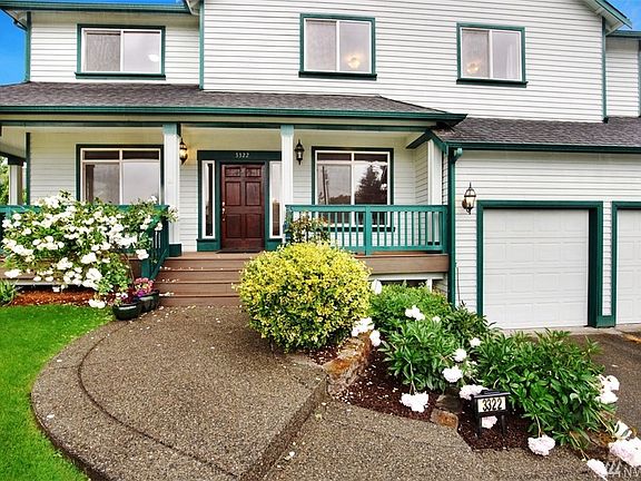 Entrance showing steps leading up to wrap around porch with accent railings leading to 42" front door!