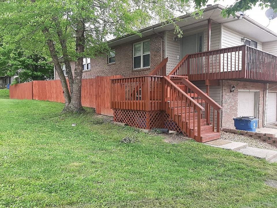Corner view of front and side of house.