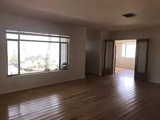 Living room with fireplace has double doors to dinning room. All rooms have blackout shades except for laundry area.