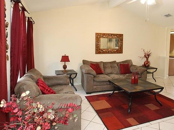 Living room area with no carpet, all tiled.