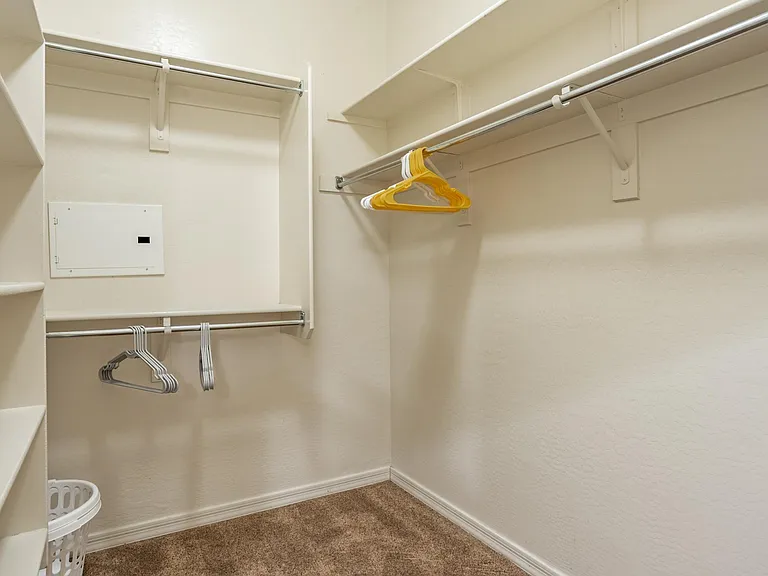 Spacious walk in closet in primary bedroom