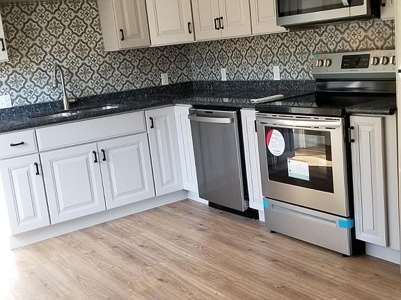 brand new kitchen with stainless steel appliances