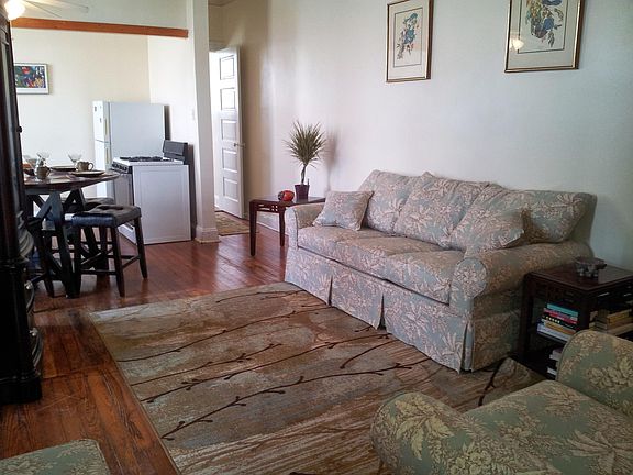 living room looking toward dining area and kitchen and back bedroom.