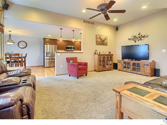 Main level family room, ceiling fan, and wired for surround sound.