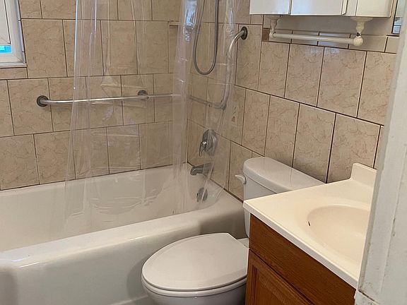 Bath room with tile floor and a deep tub