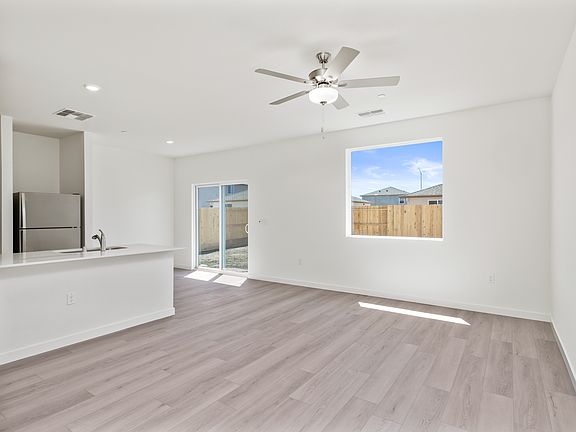 The family room is spacious with a ceiling fan.