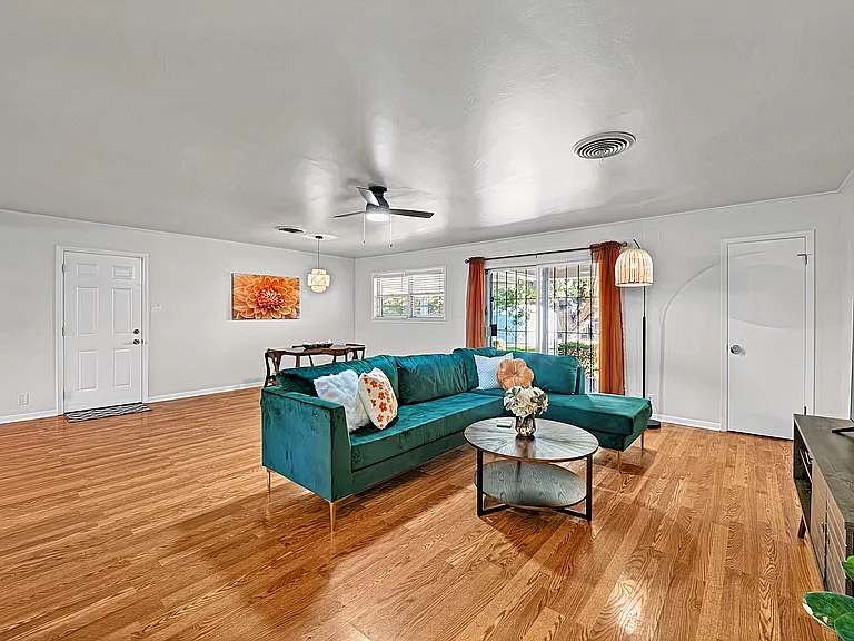 Bright living room with ample seating, Smart TV, and direct access to covered patio.