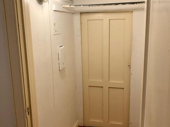 spacious storage closet in dining room - door to additional understairs storage