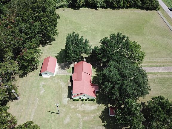 Another view of the house, garage and well house facing north.