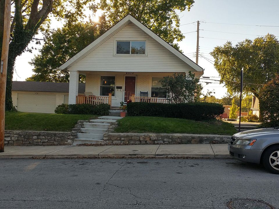 Front of house from across the street -New deck covered with closable gate on front porch.