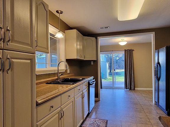 Kitchen and dining are looking towards the shop.