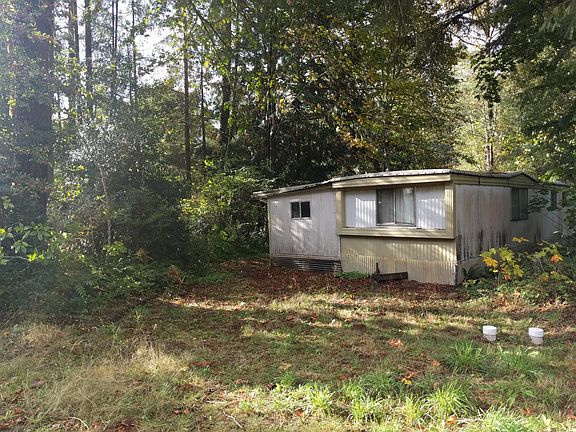 Hitch side of the trailer on the narrow end of the lot facing street (opposite of the creek) and addition
