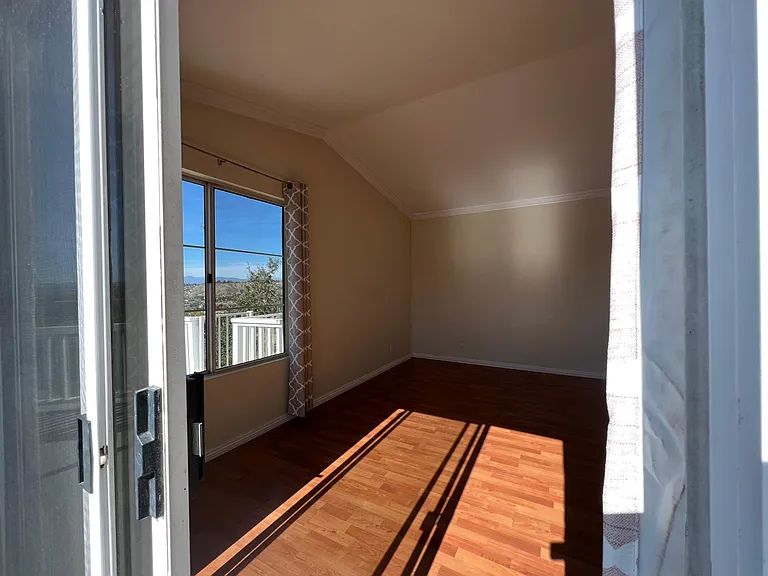 View peeking in to master bedroom from 2nd floor deck