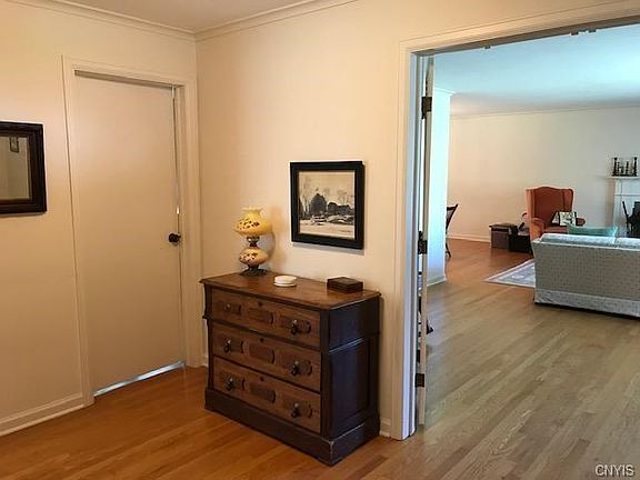 Front hallway - large living room to the right and a bedroom/den behind the closed door