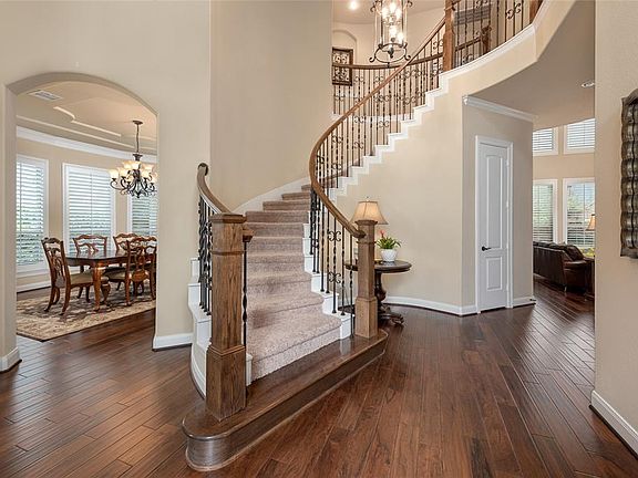As you enter the home you cannot help but be impressed with the soaring two story foyer, the gleaming hardwood floors and grand, sweeping staircase with elegant wrought iron spindles.