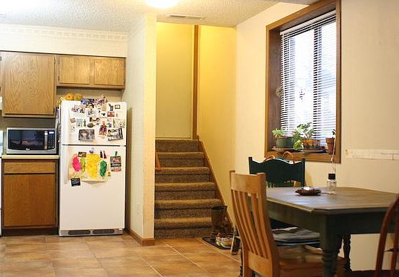 Kitchen and steps to backdoor to garage.