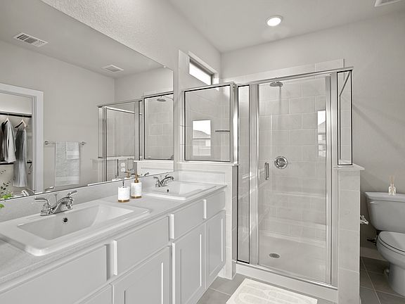 Primary Bathroom in the Birch home plan by Trophy Signature Homes - REPRESENTATIVE PHOTO