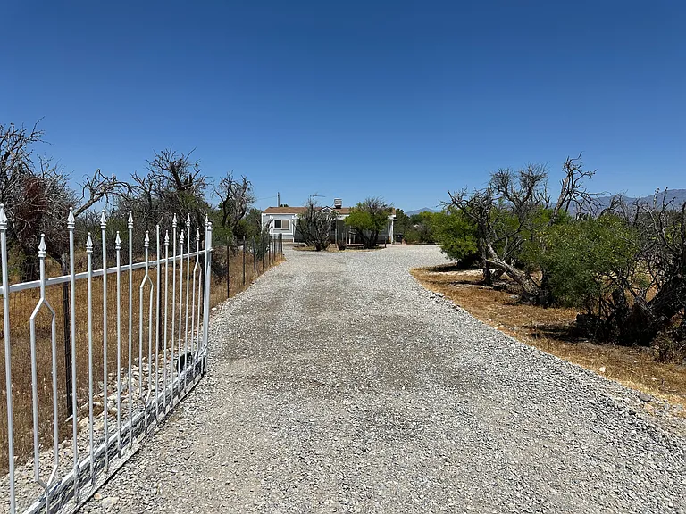 Mesquites provide privacy for this one acre with well and septic.