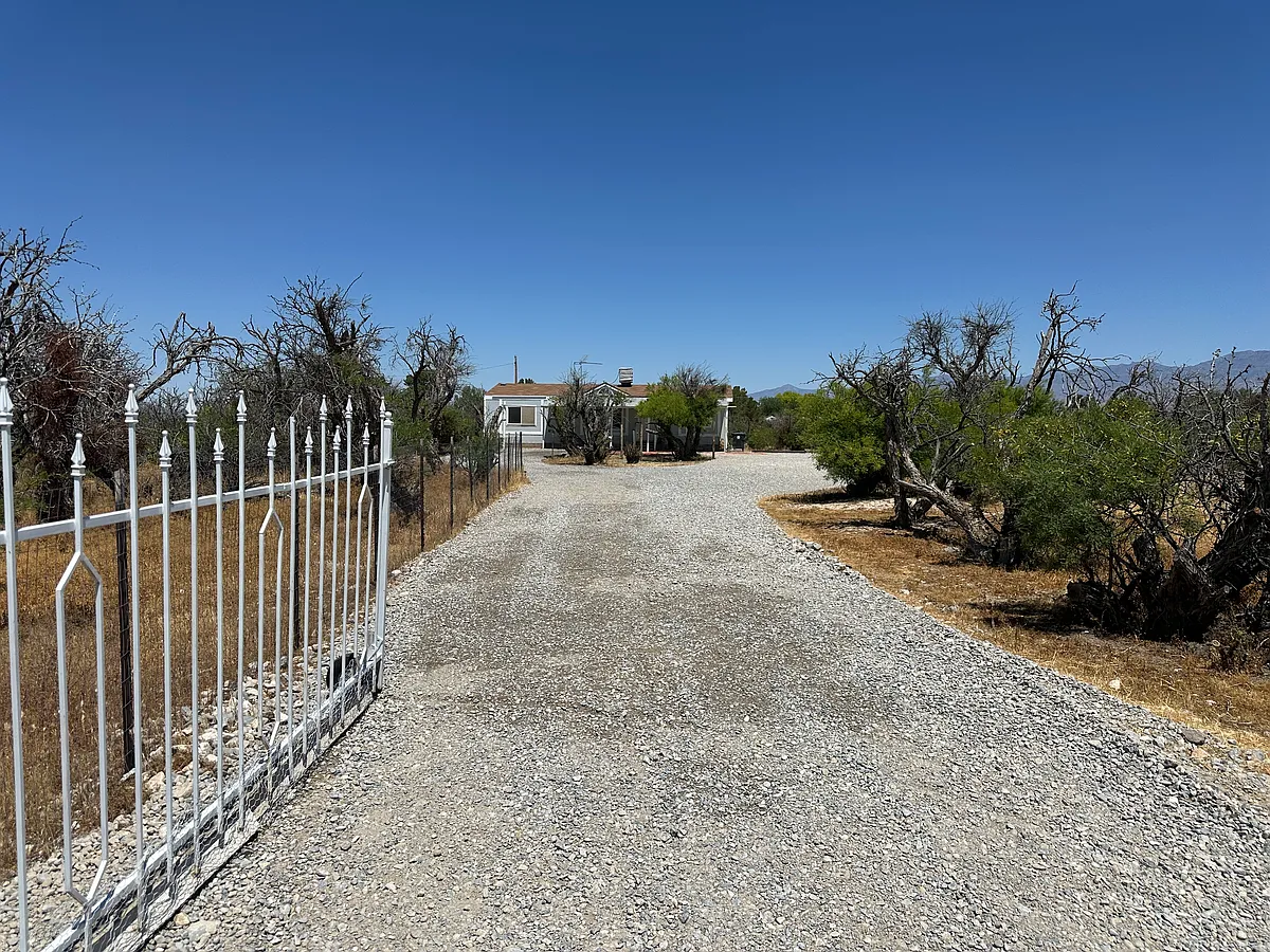 Mesquites provide privacy for this one acre with well and septic. - Derby St