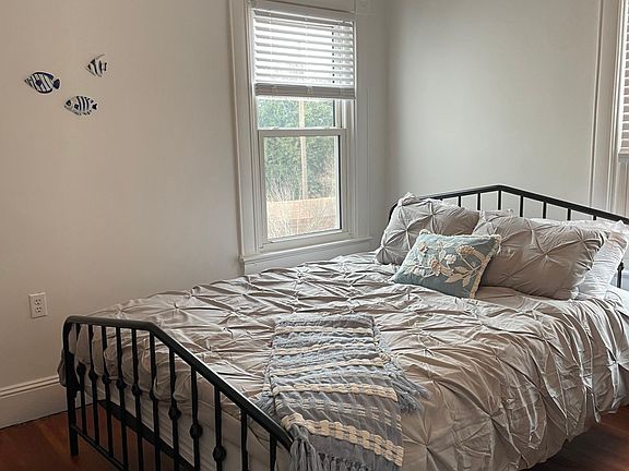2nd bedroom with queen bed, dresser, chair, closet and end table.