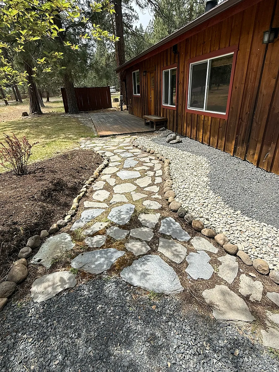 River rock and shale stone pathway lead to front porch and front door. - 69275 Stetson