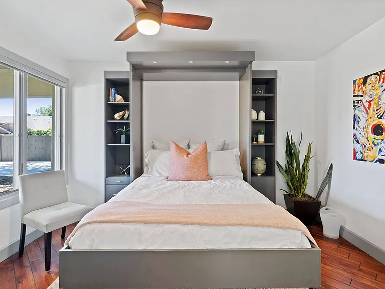 Murphy bed pulled down from workspace
Queen mattress