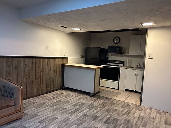 Studio with kitchenette, bathroom, and shared laundry room.