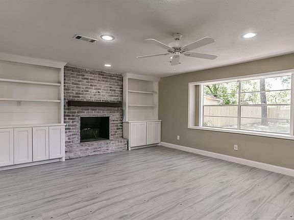 There is a ceiling fan, built-in's and a gaslog fireplace with a wood mantle in the family room.