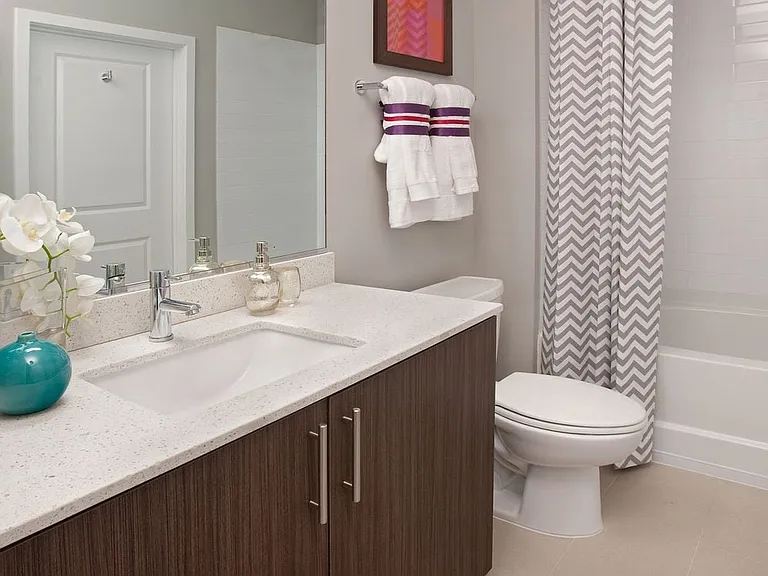 Bathroom with white quartz countertop, espresso cabinetry and hard surface flooring