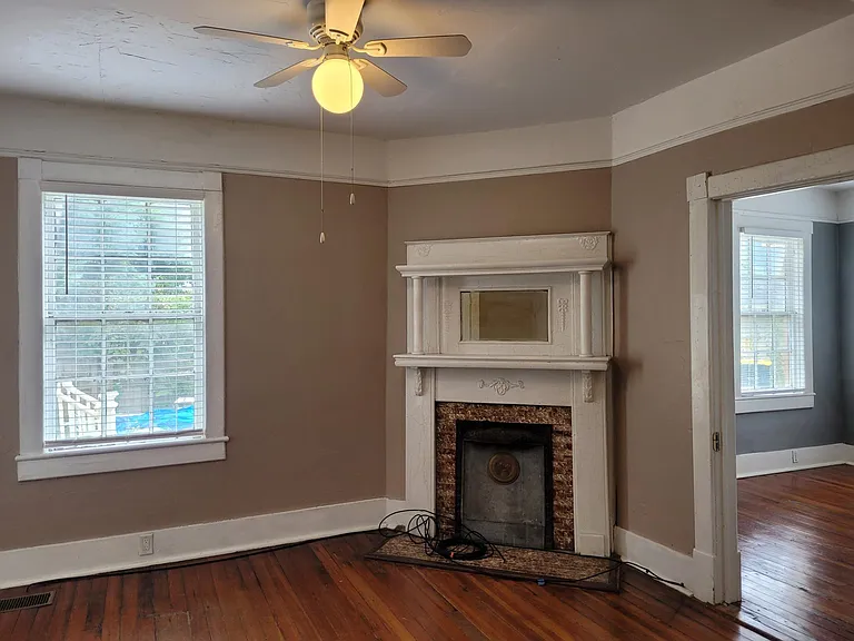 Dining - Decorative fireplace, Levolor blinds, & view of back bedroom through door