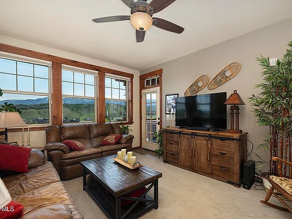 Family room with access to deck with hot tub.