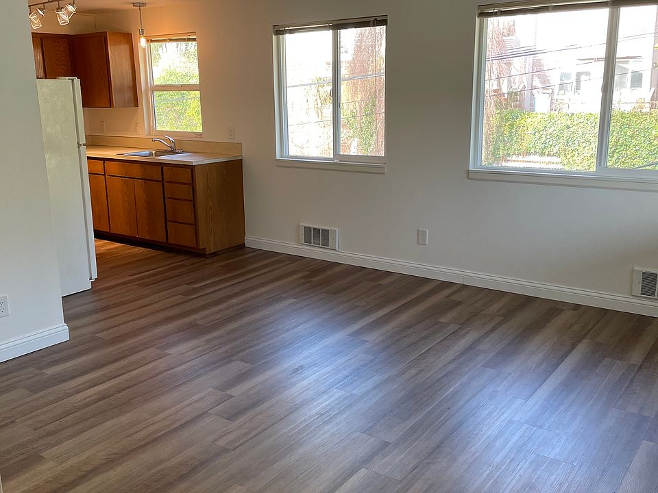 Spacious living room with large energy-efficient windows. Mini-blinds provided.