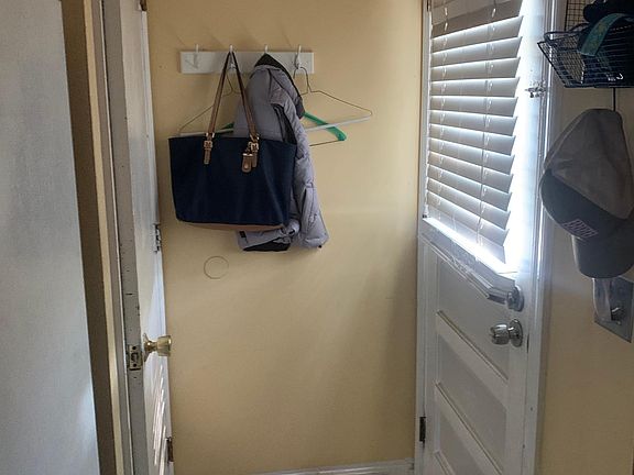 Side entrance. Opposing door leads to partially finished heated basement with washer dryer hookups.