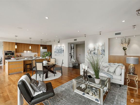Living Room: Experience tranquility and comfort in this spacious living room, boasting floor-to-ceiling windows that frame breathtaking views of the city, Stadium High School, Port of Tacoma and Commencement Bay. Picture yourself relaxing here with loved ones, soaking in the stunning scenery and natural light.>