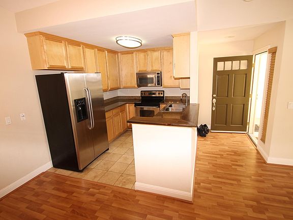Kitchen with stainless applicances: refrigerator, range, dishwasher, microwave
