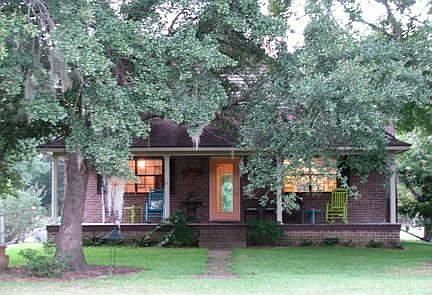 Huge rocking-chair porch overlooks lake
						:
						and the gorgeous mature trees in this huge fenced yard....plenty of shade