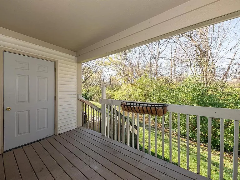 Covered deck with entrance to storage unit