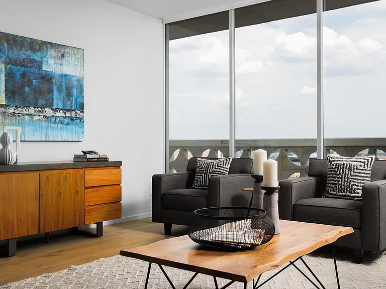 Floor to ceiling windows and sliding doors throughout the condo