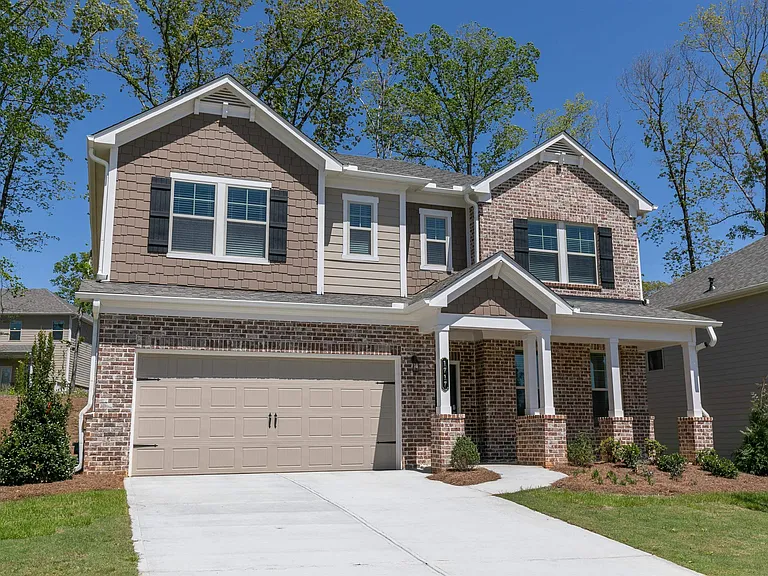 Exterior of the Prescott, two story home with a private driveway and attached garage.
