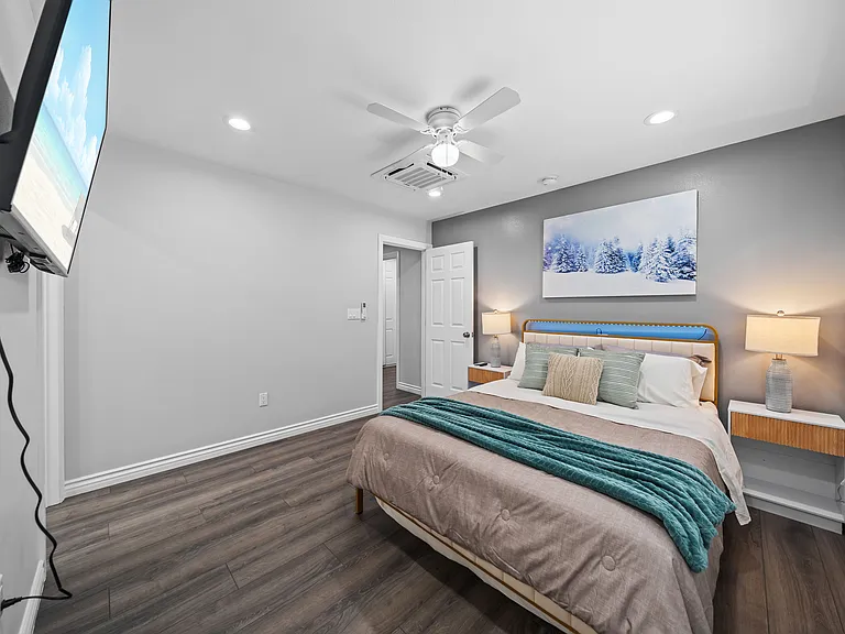 Comfortable bedroom featuring a flat-screen TV perfect for movie time.