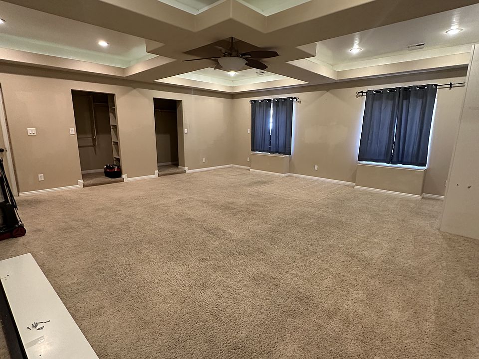 Master bedroom with recessed lighting and two walk-in closets