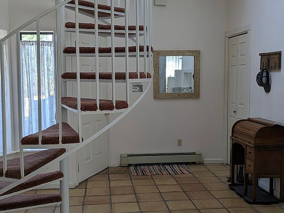 Front entryway with spiral staircase leading to second floor