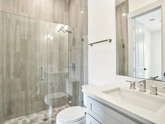 Bathroom located on the first floor. The bathroom has a tiled shower, Pfizer chrome faucet, and Kohler commode.