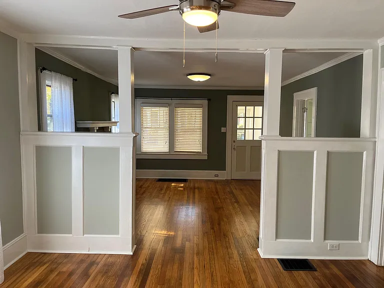 View from the kitchen doorway of the living room through the dining room.