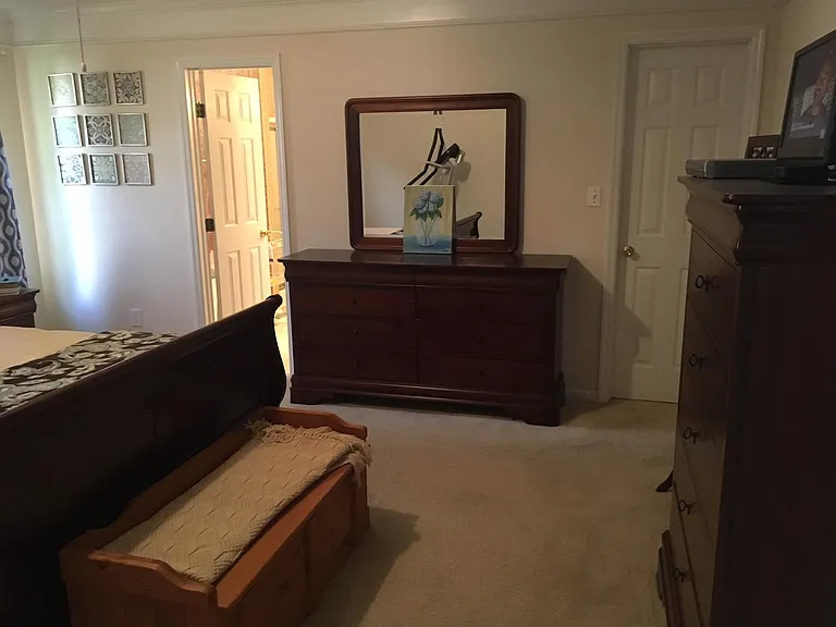 Master bedroom showing doors to bath & walk-in closet