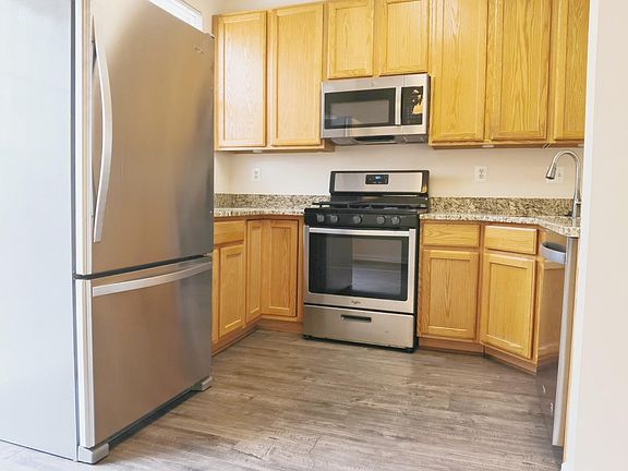 Kitchen with brand new laminate floor and SS appliances
