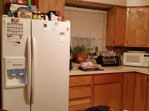 more view of kitchen. to the left of the refrigerator is the