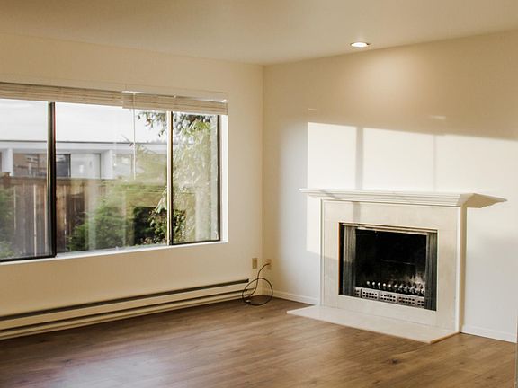 Living room with recessed lighting & wood burning fireplace.